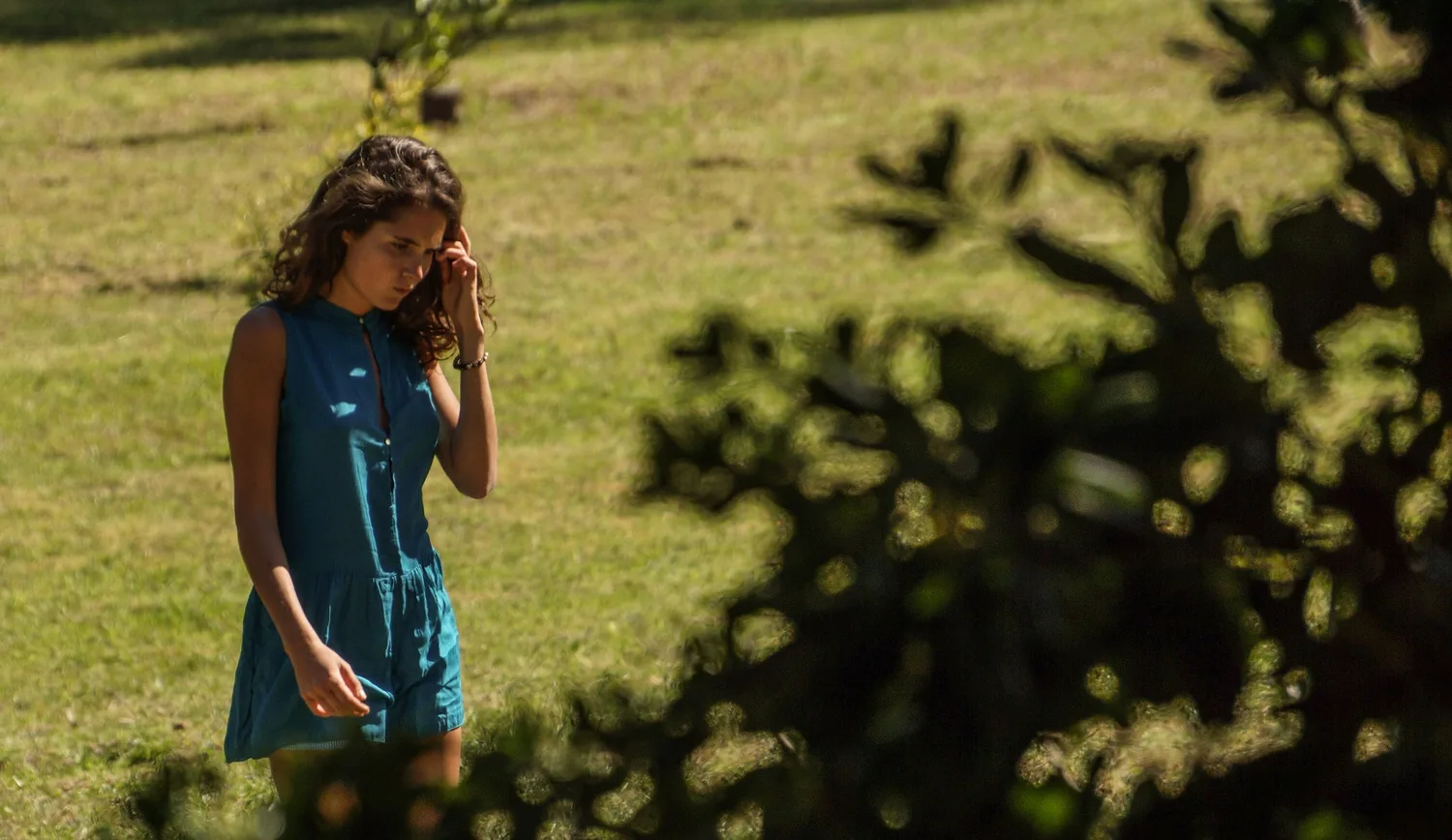 Femme en robe bleue sous les arbres de Porquerolles.